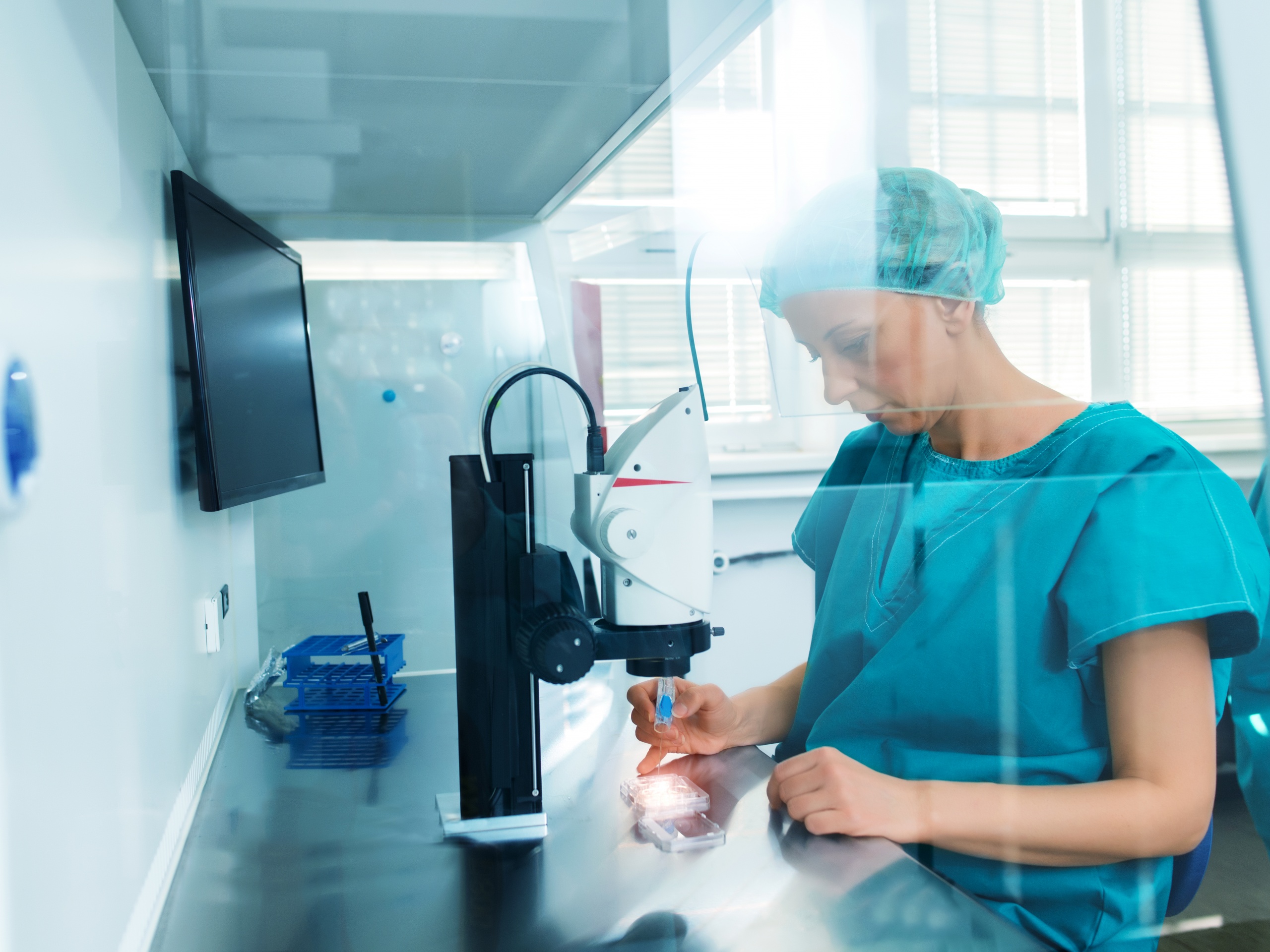 Woman working with a microscope