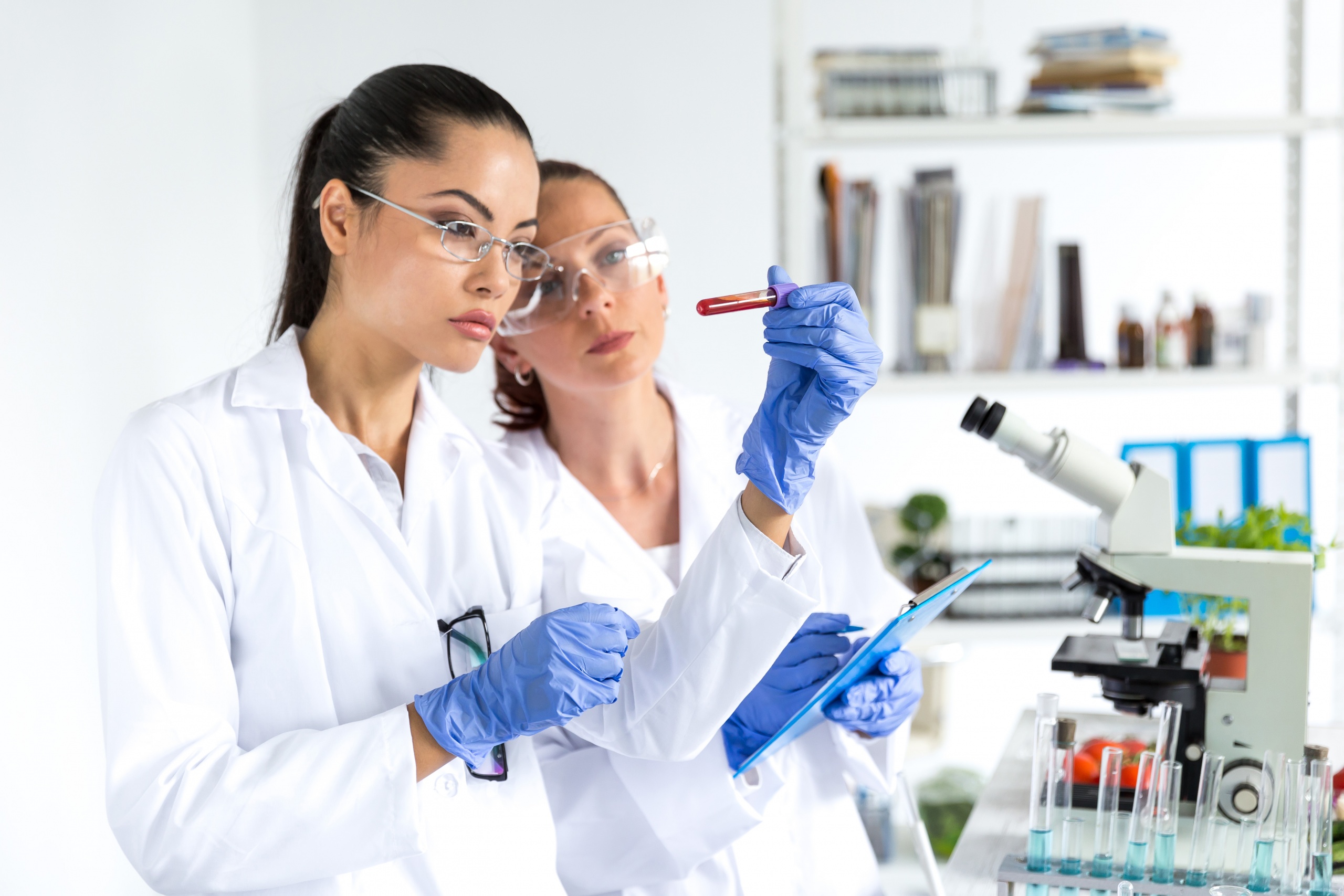 Two female laboratory technicians making blood tests.